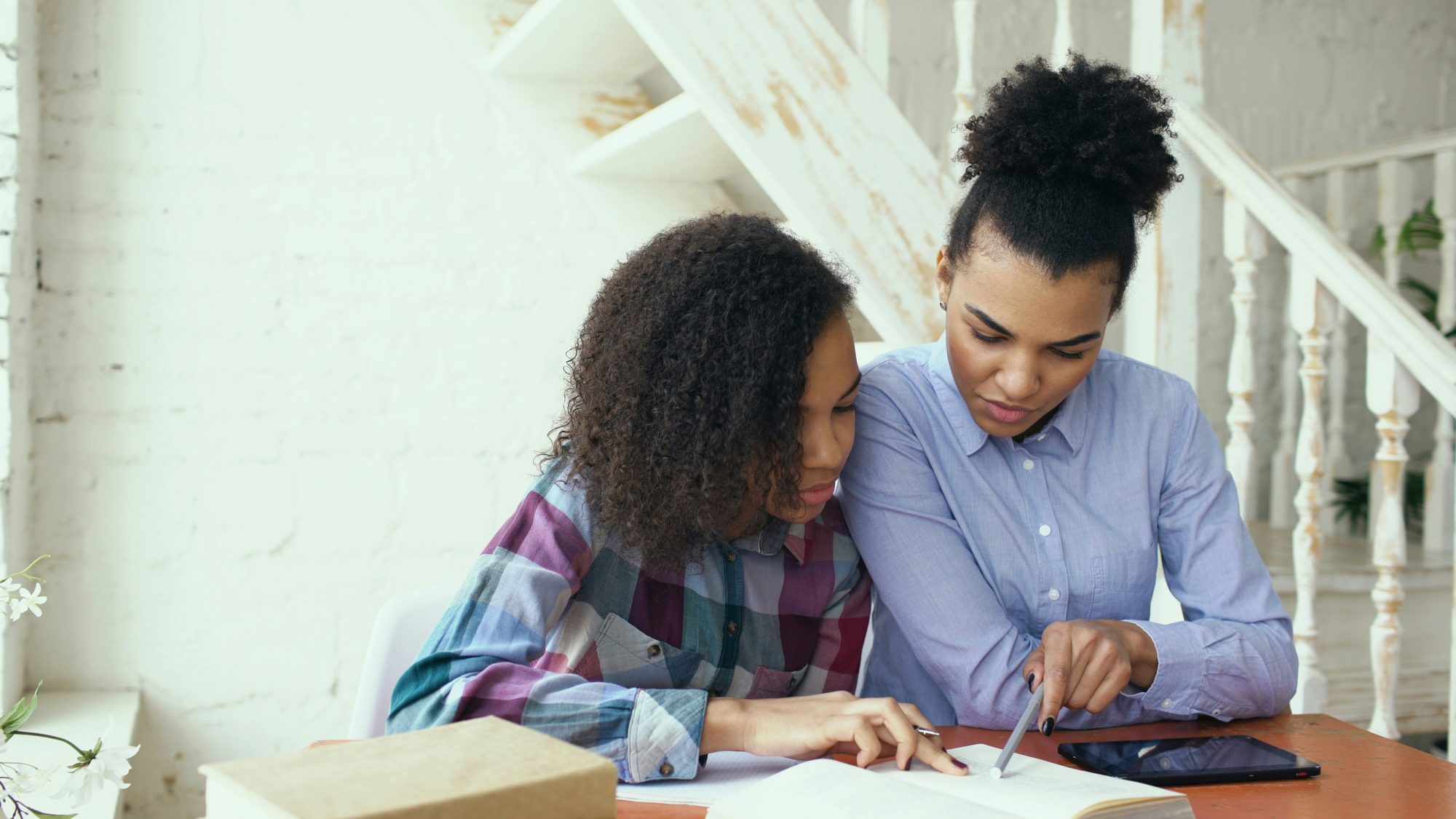 A parent and teen looking at a phone together